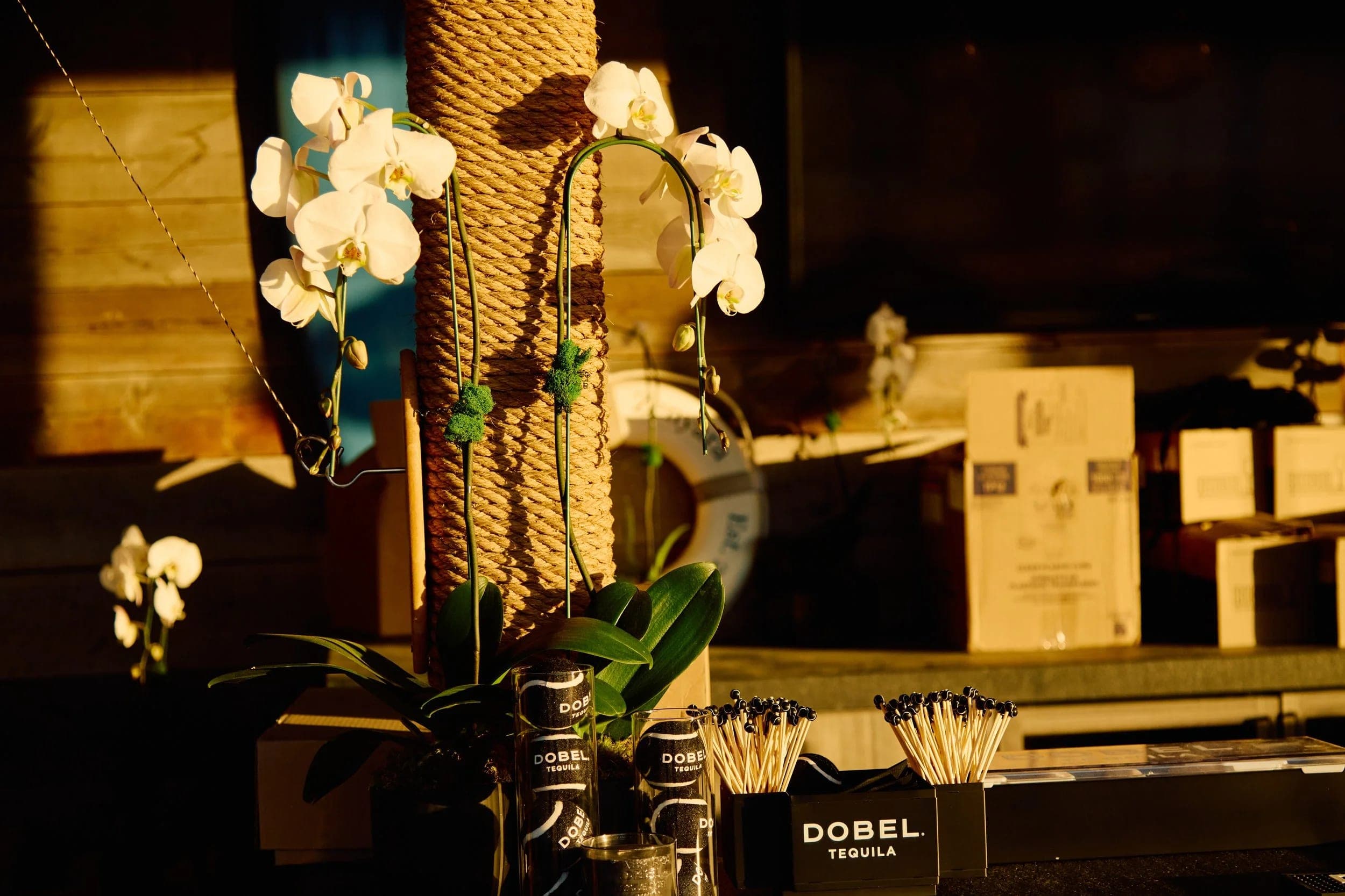 Orchids and stacked cases of tequila in the back-of-house prep area
