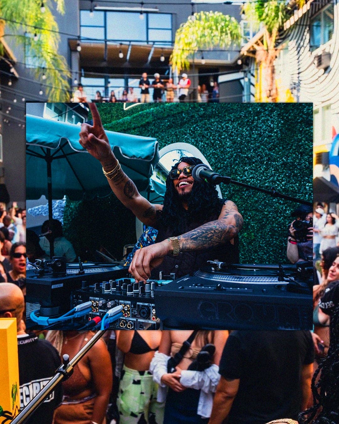 Anderson .Paak working the turntables with the packed Hotel Ziggy courtyard stretching out behind him.