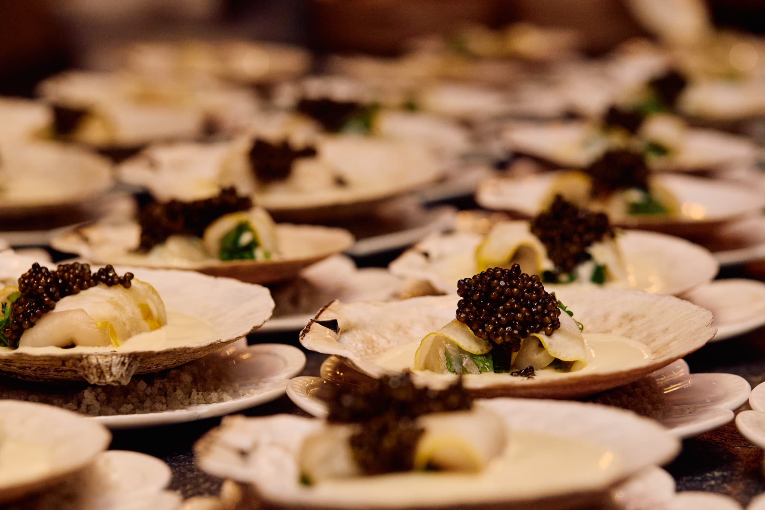Caviar spooned onto a plated course at the Desert Smash dinner.