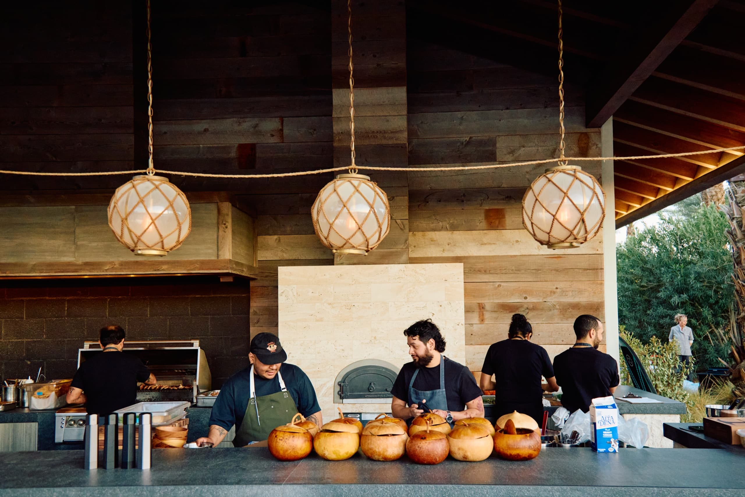 The outdoor kitchen pavilion at Zenyara Estate hung with rope lanterns, prepped for dinner service.