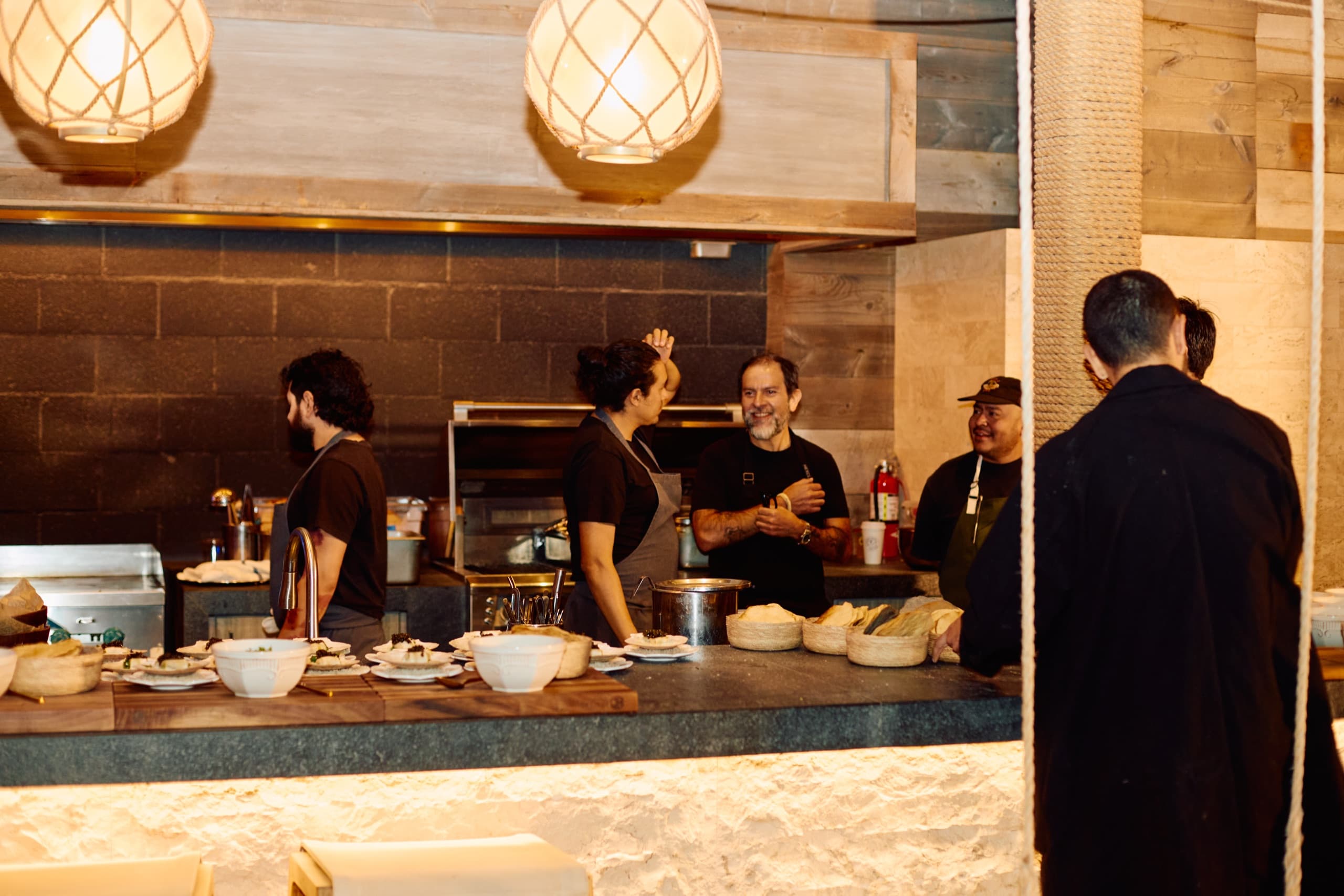 The brigade working the open kitchen at night during the Desert Smash dinner.